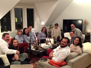 The team crowds around the coffee table for appetizers and supper.