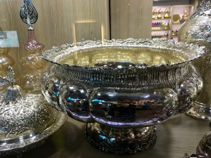 A footed bowl showing a final product similar to the one our artisan was working on.