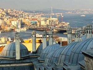 The Süleymaniye mosque complex looks out over the city. In the distance, you can see the Galata Bridge crossing over the Bosphorus Strait.