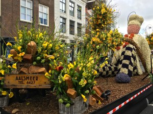 A bakery chain advertises with their float made of flowers and bulbs (look closely at the stem crossing in front of the baker.)