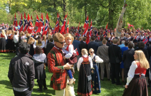 A dad in a dapper National Day outfit escorts his daughter to watch the school groups parade by.