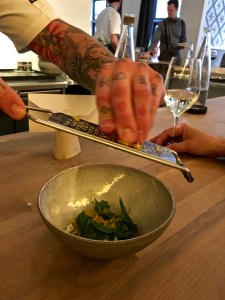 The chef showers our pork tartar with shredded egg yolks.