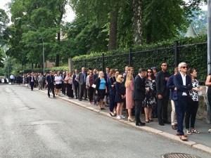 Note the breadline of guests waiting to enter the U.S. Embassy's July 4th picnic. After check-in and the usual security protocol, guests received pins sporting American and Norwegian flags (see our lapels up top.)
