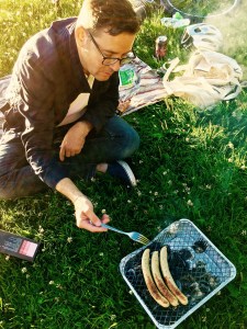Matthew tends the dogs roasting on the engang grill. Its only drawback is that the wax paper used to help fuel the flames imparts an odd taste to the food.